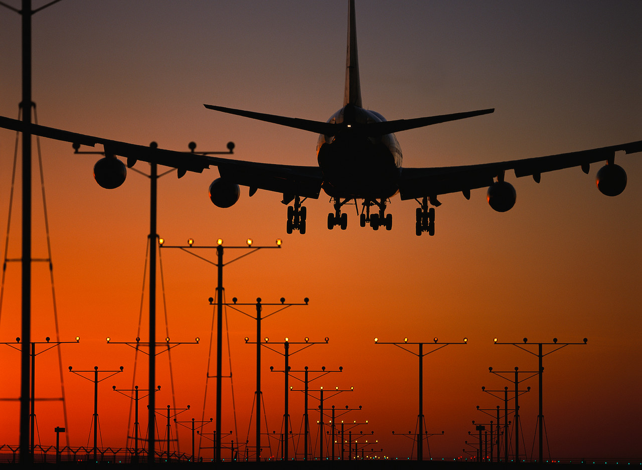 Jet Airplane Landing at Sunset