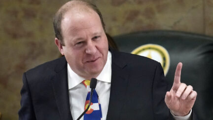 FILE - Colorado Gov. Jared Polis delivers his State of the State address to lawmakers assembled in the House of Representatives chamber in the State Capitol, Tuesday, Jan. 17, 2023, in Denver. Colorado’s governor signed four gun control bills Friday, April 28, 2023, edging the once-purple state closer to liberal-leaning governments in California and New York just months after a shooting at an LGBTQ nightclub in Colorado Springs, the latest in the state’s long history of notorious massacres.